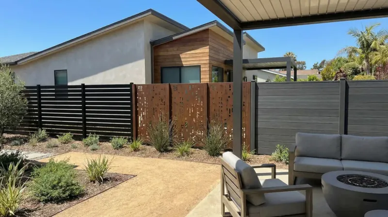 Target the fence section where it meets the house