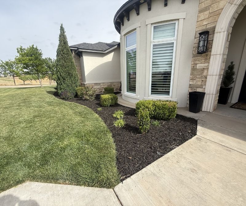Manage mulch, beds, and stone borders near the foundation